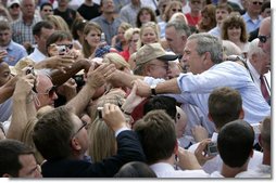 President George W. Bush greets the crowd after signing the Transportation Equity Act, at the Caterpillar facility in Montgomery, Ill., Wednesday, Aug. 10, 2005. White House photo by Eric Draper