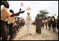 Mrs. Laura Bush and Ghana first lady Mrs. Theresa Kufuor, are greeted by singing students waving flags, on their arrival to Mallam D/A Primary School, Wednesday, Feb. 20, 2008 in Accra, Ghana. White House photo by Shealah Craighead