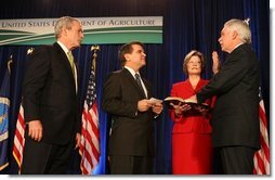 President George W. Bush listens as the Oath of Office is administered ceremoniously by Deputy Secretary Chuck Conner to U.S. Department of Agriculture Secretary Ed Schafer Wednesday, Feb. 6, 2008. Holding the Bible is Nancy Schafer, wife of the new secretary.  White House photo by Chris Greenberg