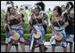 Young women in traditional costume dance during welcoming ceremonies for President George W. Bush and Mrs. Laura Bush Saturday, Feb. 16, 2008, at Julius Nyerere International Airport in Dar es Salaam, Tanzania. White House photo by Shealah Craighead