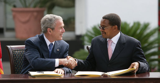 President George W. Bush and President Jakaya Kikwete of Tanzania, shake hands after signing the $698 million Millennium Challenge Compact Sunday, Feb. 17, 2008, in Dar es Salaam. In signing the compact, President Bush said, "We are partners in democracy. We believe that governments ought to respond to the people. We're also partners in fighting disease, extending opportunity and working for peace. Mr. President, I mentioned I was proud to sign, along with the President, the largest Millennium Challenge Account in the history of the United States here in Tanzania. It will provide nearly $700 million over five years to improve Tanzania's transportation network, secure reliable supplies of energy, and expand access to clean and safe water." White House photo by Chris Greenberg