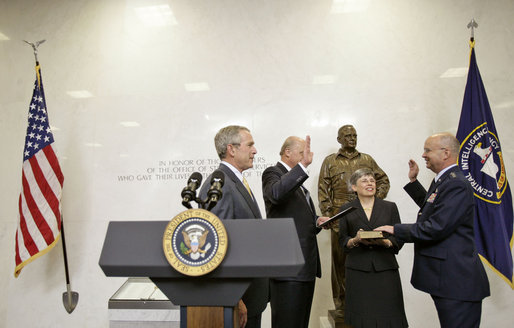 President George W. Bush attends the swearing-in of Gen. Michael Hayden as the Director of the Central Intelligence Agency by Director of National Intelligence John Negroponte at CIA Headquarters in Langley, Va., Wednesday, May 31, 2006. Pictured holding the Bible is Gen. Hayden's wife Jeanine Hayden. White House photo by Eric Draper