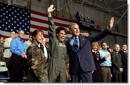 President George W. Bush is welcomed by a member of the New Hampshire Air National Guard at Pease Air National Guard Base in Portsmouth, N.H., Thursday, Oct. 9, 2003.   White House photo by Tina Hager