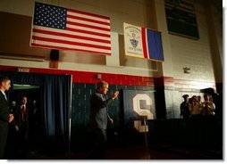 President George W. Bush salutes law enforcement officers before participating in a conversation on High School Initiatives at Parkersburg South High School in Parkersburg, W. Va., Thursday, May 13, 2004.  White House photo by Paul Morse