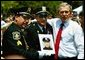 President George W. Bush stands for pictures during the Annual Peace Officers' Memorial Service at the U.S. Capitol in Washington, D.C., Saturday, May 15, 2004. "Our fallen officers died in service to justice, and in defense of the innocent," said President Bush. "They will never be forgotten by their comrades, they will never be forgotten by their country." White House photo by Paul Morse