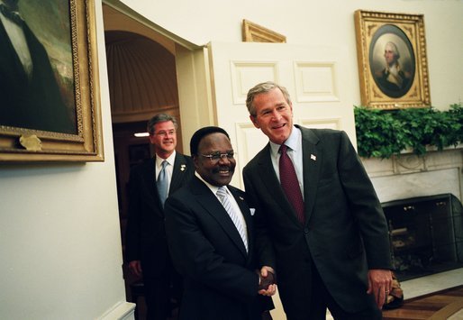 President George W. Bush welcomes President Omar Bongo Ondimba of Gabon to the Oval Office Wednesday, May 26, 2004. White House photo by Eric Draper.