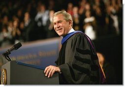 President George W. Bush imparts some light-hearted audience to the graduating students at the Louisiana State University Commencement in Baton Rouge, La., Friday, May 21, 2004. "As you enter professional life, I have a few other suggestions about how to succeed on the job. For starters, be on time. It's polite, and it shows your respect for others. Of course, it's easy for me to say," said the President. "It's easy for me to be punctual when armed men stop all the traffic in town for you."  White House photo by Eric Draper