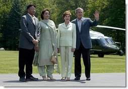 President Pervez Musharraf, his wife, Sehba Musharraf, President George W. Bush and Laura Bush stand for a group photo shortly after the press conference at Camp David Tuesday, June 24, 2003.  White House photo by David Bohrer