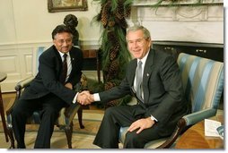 President George W. Bush and Pakistan President Pervez Musharraf pose during a photo-op in the Oval Office Saturday, Dec. 4, 2004. White House photo by Tina Hager