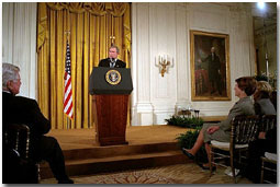 President George W. Bush addresses the White House Conference on Preparing Tomorrow's Teachers in the East Room March 4, 2002. Pictured in the audience from left to right is U. S. Sen. Edward Kennedy (D-Mass.), Laura Bush and Lynne Cheney. "We're focusing much of the teacher training effort on specific needs, like special education or math or science, and one of my passions, early reading," said the President. "The Reading First program is aimed at making sure every child of every background can read by the third grade." White House photo by Eric Draper.