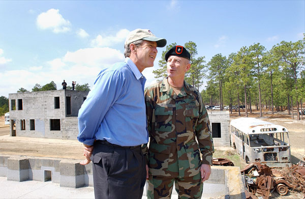President George W. Bush and Brigadier General Richard Mills, Deputy Commander of U.S. Special Forces, view a tactical demonstration from the roof of a building at Fort Bragg, North Carolina, Friday, March 15, 2002. White House photo by Eric Draper.