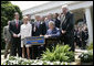 President George W. Bush is joined by Senate and House members as he signs H.R. 4472, the Adam Walsh Child Protection and Safety Act of 2006 at a ceremony Thursday, July 27, 2006, in the Rose Garden at the White House, as John Walsh, center, and his wife, Reve Walsh, look on. The bill is named for the Walsh’s six-year-old son Adam Walsh who was abducted and killed 25 years ago. White House photo by Eric Draper