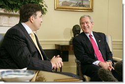 President George W. Bush and Georgian President Mikhail Saakashvili talk to the press in the Oval Office Wednesday, July 5, 2006. "He believes in the universality of freedom. He believes that democracy is the best way to yield the peace. The Georgian government and the people of Georgia have acted on those beliefs," said President Bush. "I want to thank you for your contribution in Iraq, to help the Iraqi people realize the great benefits of democracy."  White House photo by Kimberlee Hewitt