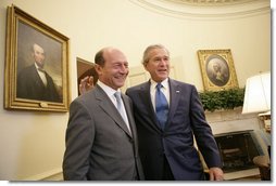 President George W. Bush welcomes Romanian President Traian Basescu to the Oval Office at the White House Thursday, July 27, 2006 in Washington, D.C.  White House photo by Eric Draper