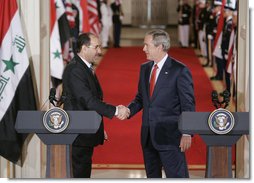 President George W. Bush shakes hands with Iraqi Prime Minister Nouri al-Maliki at the conclusion of their joint press availability in the East Room of the White House Tuesday, July 25, 2006. White House photo by Kimberlee Hewitt