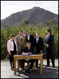 President George W. Bush is joined by Arizona legislators as he signs H.R. 5441, Department of Homeland Security Appropriations Act for fiscal year 2007, Wednesday, Oct. 4, 2006, against a backdrop of Camelback Mountain in Scottsdale. From left are: Arizona Gov. Janet Napolitano, Rep. J.D. Hayworth, Rep. Rick Renzi, Sen. Jon Kyl, R-Ariz., and Rep. Trent Franks. White House photo by Eric Draper