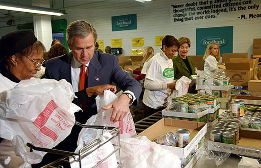 President George W. Bush and Laura Bush help volunteers pack food during their visit to the Capital Area Food Bank in Washington, D.C., Thursday, Dec. 19. "More Americans need to volunteer. There are ways to do so. The USAFreedomCorps.gov on the web page is the place to look," said the President in his remarks. "You can call 1-877-USA-CORPS and find out ways that you can help. If you are interested in being a part of feeding those who hunger, this is a great place to come to." White House photo by Tina Hager.