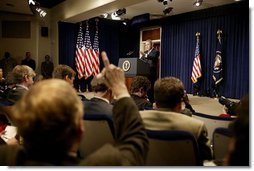 Discussing President George W. Bush takes questions during a press conference in the Dwight D. Eisenhower Executive Office Building Monday, Dec. 15, 2003.  White House photo by Paul Morse