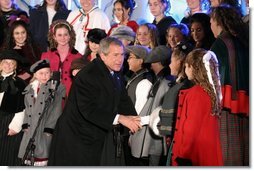 President George W. Bush greets the Voena Children's Choir at the Pageant of Peace after lighting the National Christmas Tree at the Ellipse in Washington DC on Thursday December 4, 2003.  White House photo by Paul Morse