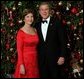 President George W. Bush and Laura Bush pose for their official Christmas portrait in front of the White House Christmas Tree in the Blue Room, Dec. 7, 2003. This year's holiday theme at the White House celebrates children's storybook characters with, "A Season of Stories." More information about the theme and decorations can be viewed at www.whitehouse.gov/holiday/. White House photo by Eric Draper