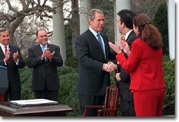 President George W. Bush signs papers with Latino leaders during a ceremony transmitting his tax cut proposal to Congress in the Rose Garden of the White House on Thursday February 8, 2001 (WHITE HOUSE PHOTO/DAVID SCULL)