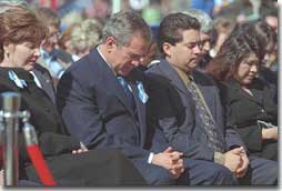 President George W. Bush and Laura Bush bow their heads in prayer at the dedication ceremony for the Oklahoma City National Memorial February 19, 2001. (White House Photo by Paul Morse)