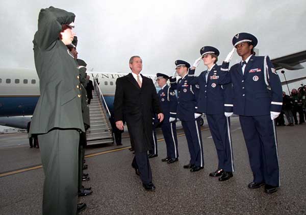 President George W. Bush is saluted as he arrives at Yeager Field to visit the 130th Air Lift Wing of the Air National Guard in Charleston, West Virginia on February 14, 2001