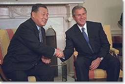 President Bush shakes hands with Prime Minister Yoshiro Mori during a meeting in the Oval Office. The leaders issued a joint statement.