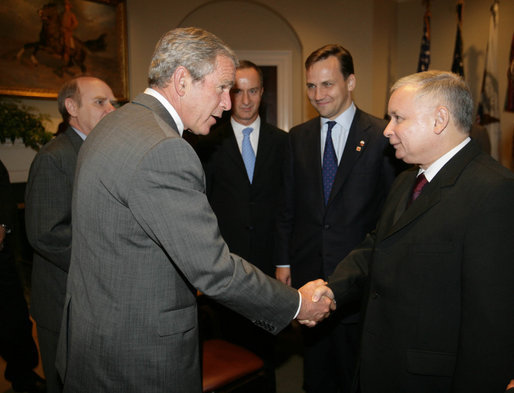 President George W. Bush drops by a meeting between Vice President Dick Cheney and Prime Minister Jaroslaw Kaczynski of Poland Wednesday, Sept. 13, 2006, in the Roosevelt Room of the White House. White House photo by David Bohrer