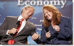 President George W. Bush talks with Kim Wilkerson during a conversation on higher education and job training at Florida Community College in Jacksonville, Fla., Friday, Jan. 14, 2005.  White House photo by Paul Morse