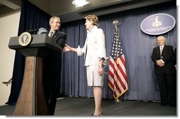 President George W. Bush congratulates Margaret Spellings, the new Secretary of Education, during her swearing-in ceremony at the Department of Education in Washington, D.C., Monday, Jan. 31, 2005. Also pictured, right, is Secretary Spellings husband, Robert Spellings.   White House photo by Paul Morse