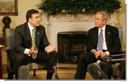 President George W. Bush listens as Mikhail Saakashvili offers remarks as they meet Wednesday, March 19, 2008, in the Oval Office of the White House. President Saakashvili expressed his gratitude for America's support, saying, "I have to thank you, Mr. President, for your unwavering support for our freedom, for our democracy, for our territorial sovereignty, and for protecting Georgia's borders, and for Georgia's NATO aspiration."  White House photo by Joyce N. Boghosian