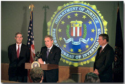 President Bush addresses the media during a tour of FBI headquarters with director Robert Mueller, left, and Attorney General John Ashcroft Sept. 25. The President visited the offices to personally thank employees for their recent and contined efforts since the Sept. 11 attack. White House photo by Paul Morse.