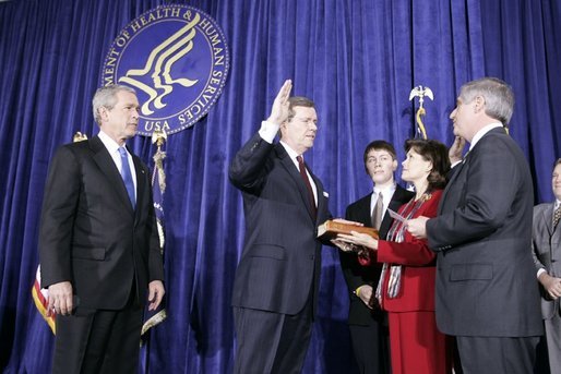 As President George W. Bush looks on, Mike Leavitt is sworn into office as Secretary of Health and Human Services by Chief of Staff Andrew Card. With Mr. Leavitt are his wife, Jackie, and son, Westin. The ceremony took place in the Great Hall at the U.S. Department of Health and Human Services. White House photo by Paul Morse.