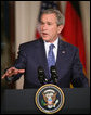 President George W. Bush gestures as he addresses his remarks during a joint news conference with German Chancellor Angela Merkel at the White House, Thursday, Jan. 4, 2006, discussing issues on security and peace in the Middle East, allied security efforts in Afghanistan and U.S.-European economic interest. White House photo by Paul Morse