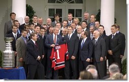 President George W. Bush poses with the 2003 Stanley Cup Champion New Jersey Devils ice hockey team Monday afternoon, September 29, 2003, in the Rose Garden.  White House photo by Jennifer Smith