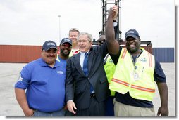 President George W. Bush joins port workers for a photo following his remarks on U.S. trade policy Tuesday, March 18, 2008, at the Blount Island Marine Terminal in Jacksonville, Fla. White House photo by Chris Greenberg