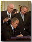 President George W. Bush signs the Patriot Act, Anti-Terrorism Legislation, in the East Room Oct. 26.  "With my signature, this law will give intelligence and law enforcement officials important new tools to fight a present danger," said the President in his remarks. White House photo by Eric Draper
