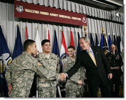 President George W. Bush shakes hands with newly sworn-in American citizens, Specialist Sergio Lopez, 24, of Bolingbrook, Ill., left, Specialist Noe Santos-Dilone of Brooklyn, N.Y., center, and Private First Class Eduardo Leal-Cardenas of Los Angeles, Calif., during their naturalization ceremony Monday, July 24, 2006, at Walter Reed Army Medical Center in Washington, D.C. White House photo by Eric Draper