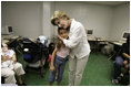 First Lady Laura Bush hugs a young girl displaced by Hurricane Katrina during her visit Friday, Sept. 2, 2005, to the Cajundome at the University of Louisiana in Lafayette.  "Some things are working very, very well in Louisiana," Mrs. Bush said.  "And certainly this center is one of those..."