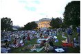 Awaiting a show of explosions of color, White House staff members and their families relax on the South Lawn Thursday, July 4. Shortly before the fireworks began, President Bush joined the party and watched the display from the Truman Balcony.