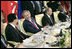 President George W. Bush talks with Chinese President Hu Jintao, left, during a luncheon with world leaders during the G8 Summit at the Konstantinovsky Palace Complex Monday, July 17, 2006 in Strelna, Russia. Also pictured is Russian President Vladimir Putin, and South African President Thabo Mbeki, far-right.