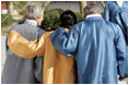 Robed in traditional garb, President George W. Bush walks arm-in-arm with Japan's Prime Minister Junichiro Koizumi, right, and Peru's President Alejandro Toledo outside the Nurimaru APEC House in Busan, Korea, Saturday, Nov. 19, 2005, for the APEC official photograph.