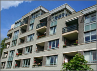 Photo of the exterior of an apartment building. Copyright iStockphoto.com.