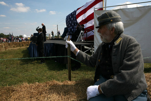 Vice President Dick Cheney delivers remarks during the commemoration of the 145th anniversary of the Battle of Chickamauga in McLemore's Cove, Georgia. as a Confederate re-enactment participant looks on. White House photo by David Bohrer