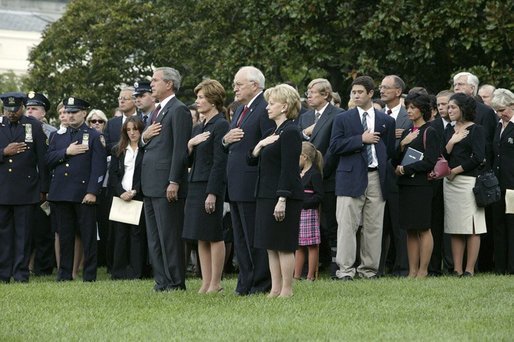 President George W. Bush, Mrs. Bush, Vice President Dick Cheney and Mrs. Cheney, stand by families of victims of 911 during the playing of Taps following a Moment of Silence on the South Lawn, Saturday, Sept. 11, 2004. White House photo by David Bohrer.