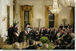 President George W. Bush, Mrs. Laura Bush and their invited guests listen to country singer Kenny Chesney perform in the East Room of the White House Tuesday evening, May 16, 2006, at the official dinner for Australian Prime Minister John Howard and Mrs. Janette Howard. White House photo by Paul Morse