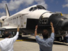 Michael Griffin, center in white, and other NASA Managers give a thumbs up to the crew of the space shuttle Endeavour shortly after touch down.