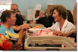 Laura Bush meets with people while visiting a clothing distribution site at the Biloxi Community Center, Tuesday, Sept. 27, 2005 in Biloxi, Miss., where she also interviewed with the television program, ABC's Extreme Makeover: Home Edition.  White House photo by Krisanne Johnson