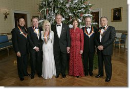 President George W. Bush and Mrs. Laura Bush stand with the Kennedy Center honorees in the Blue Room of the White House during a reception Sunday, Dec. 3, 2006. From left, they are: singer and songwriter William "Smokey" Robinson; musical theater composer Andrew Lloyd Webber; country singer Dolly Parton; film director Steven Spielberg; and conductor Zubin Mehta.  White House photo by Eric Draper